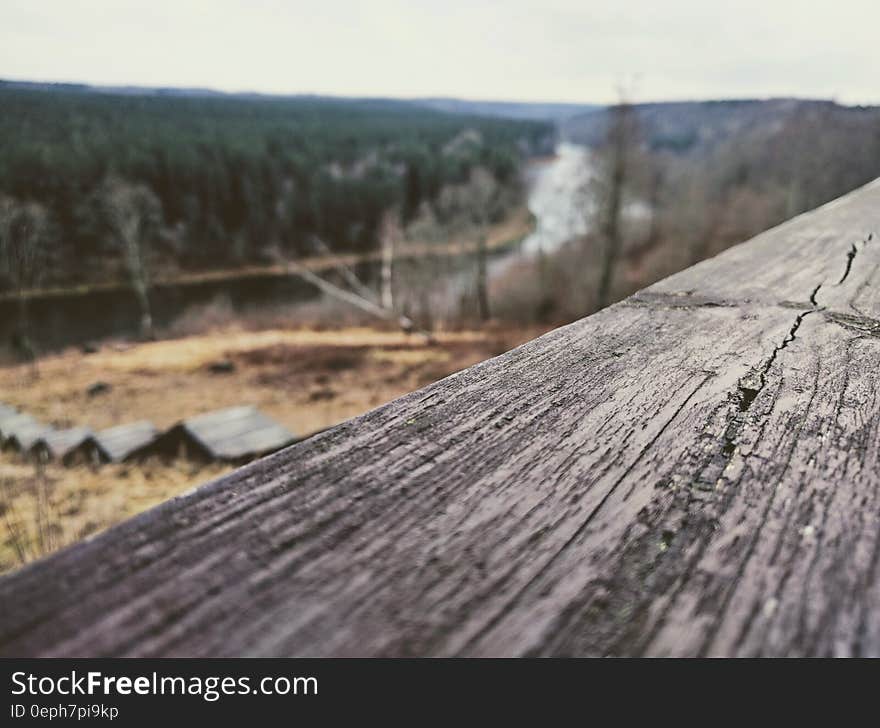 Close up of wooden board overlooking river valley in countryside. Close up of wooden board overlooking river valley in countryside.