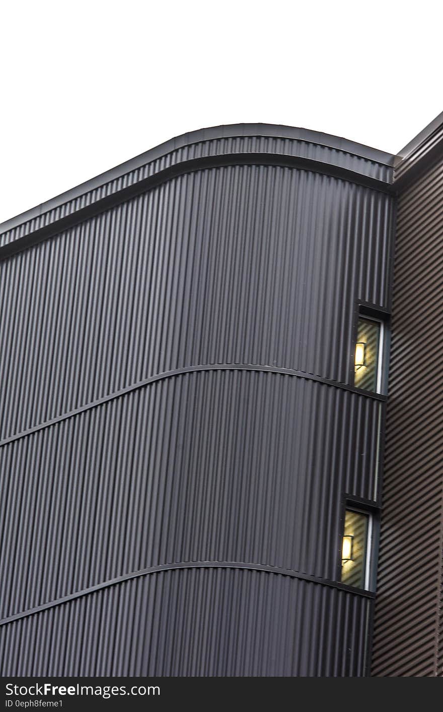 Exterior wall with windows of modern building against overcast skies. Exterior wall with windows of modern building against overcast skies.