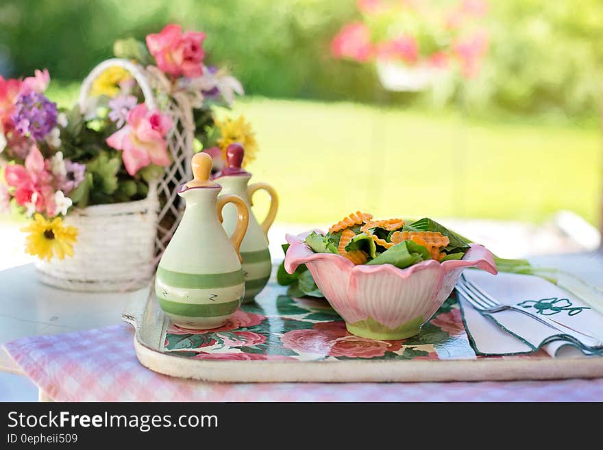 Biscuits on White Ceramic Bowl Beside White Ceramic Container on Silver and White Tray