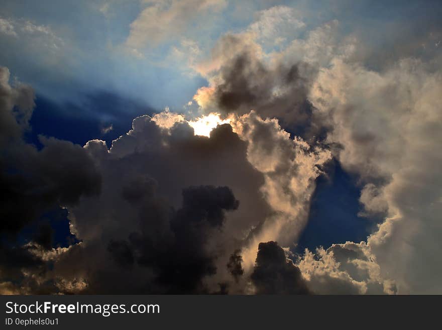 Gray Clouds Cover Sun Under Blue Sky