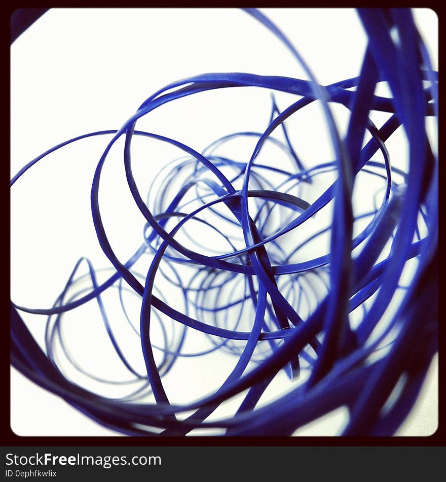 Abstraction of looping coils of blue cables on white. Abstraction of looping coils of blue cables on white.