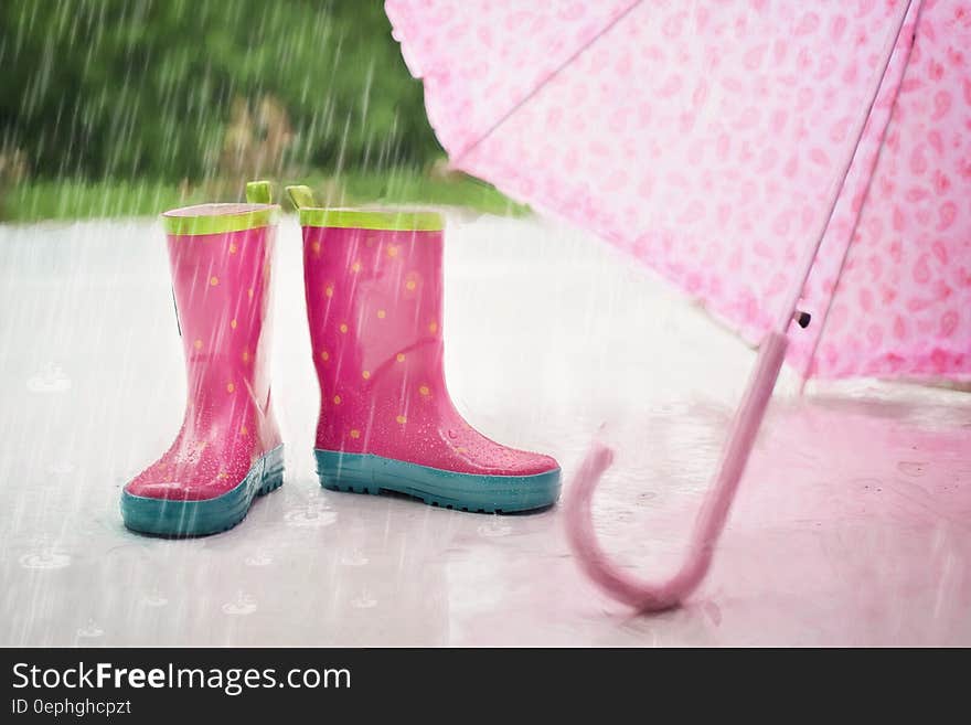 Red and Gray Rain Boots Near Pink Umbrella