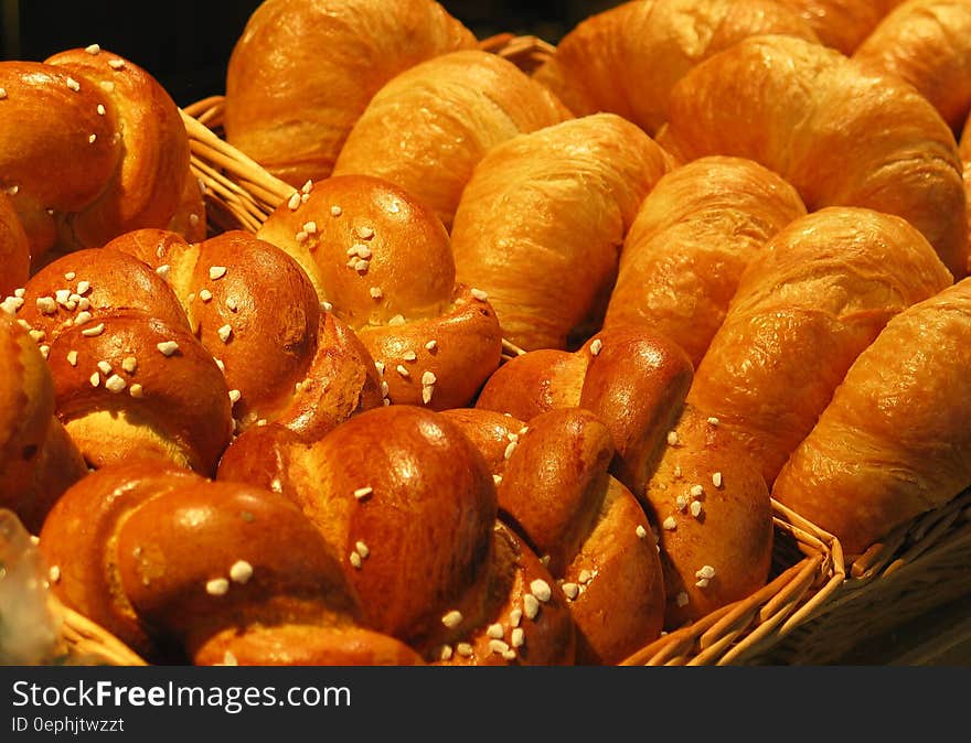 Close up of baked pretzel rolls and croissants in wicker baskets. Close up of baked pretzel rolls and croissants in wicker baskets.