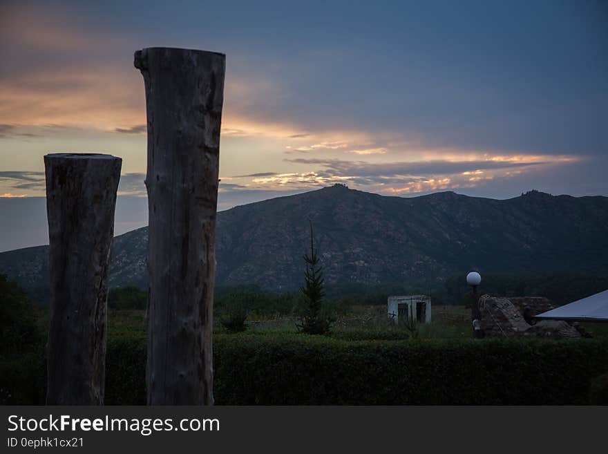 Sunset behind mountain peaks in blue skies. Sunset behind mountain peaks in blue skies.