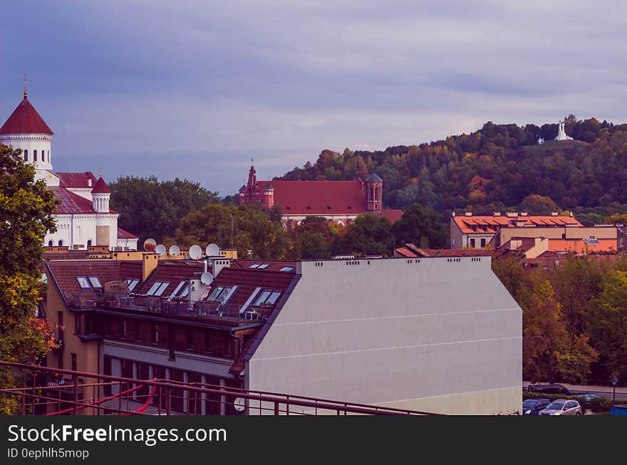 White and Brown Painted Building Surrounded by Green Trees during Sunset