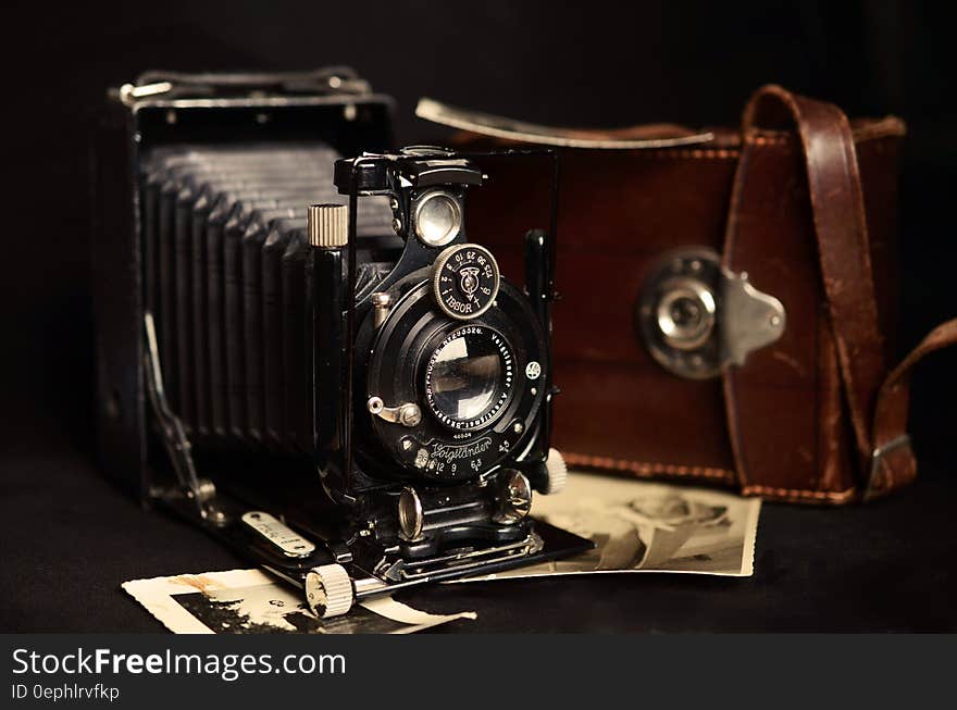 Black Classic Camera Near Brown Leather Bag