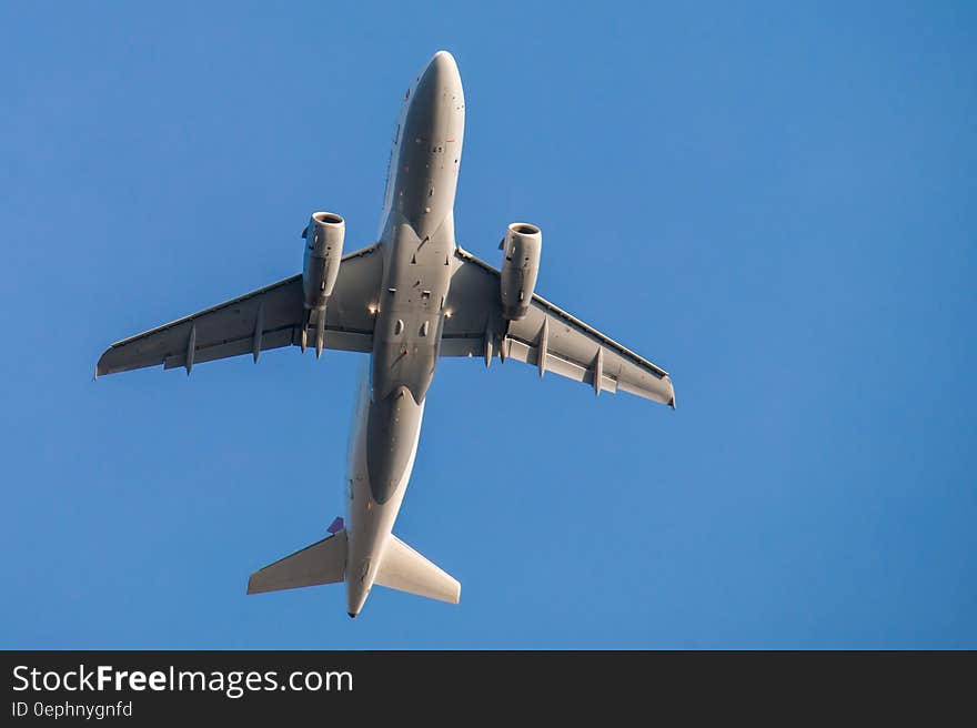 Airplane flying overhead against blue skies. Airplane flying overhead against blue skies.