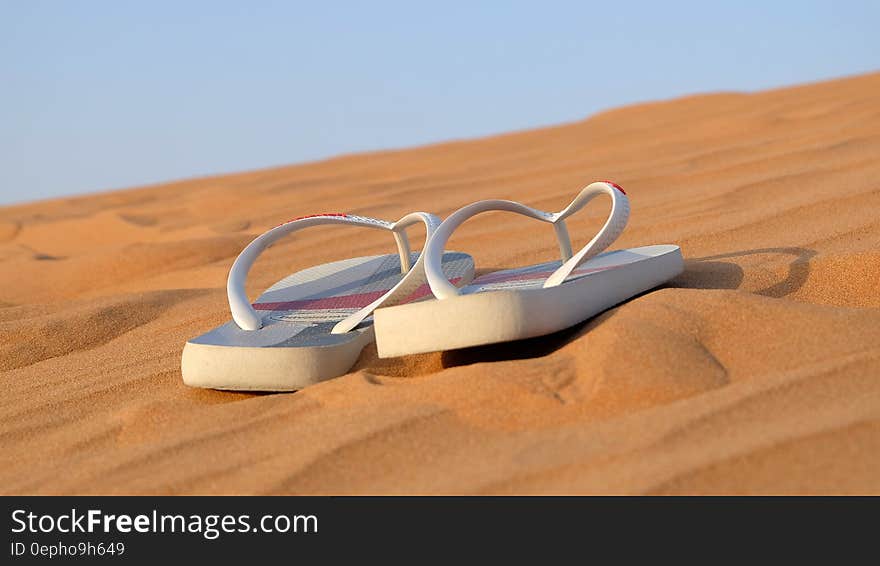 Sandals on desert sand on sunny day. Sandals on desert sand on sunny day.