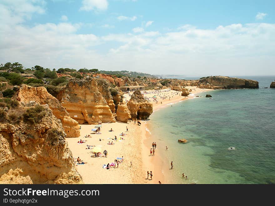 Aerial view of tourists on sandy coastal beach on sunny day. Aerial view of tourists on sandy coastal beach on sunny day.