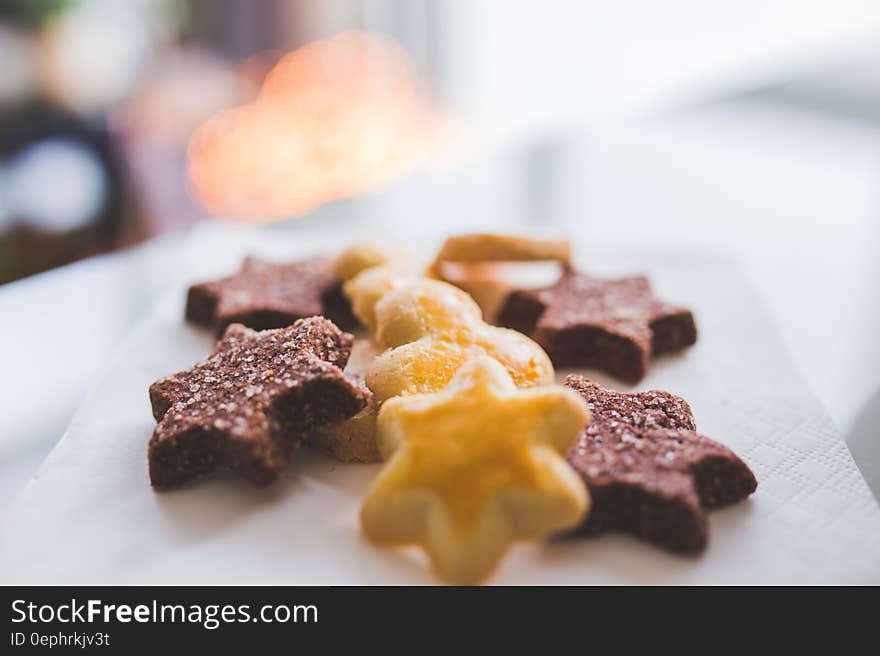 Close up of chocolate and vanilla star shaped cookies on white china plate. Close up of chocolate and vanilla star shaped cookies on white china plate.