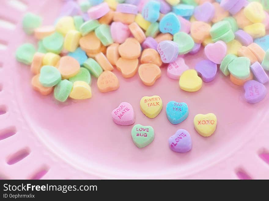 Valentine's Day heart candies on pink plate. Valentine's Day heart candies on pink plate.