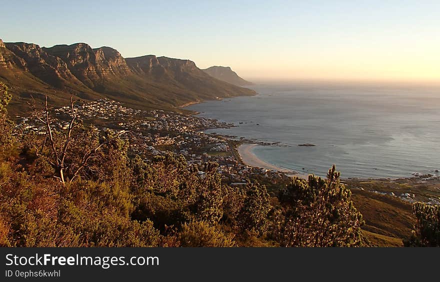 Rocky shores of South African beach at sunset.