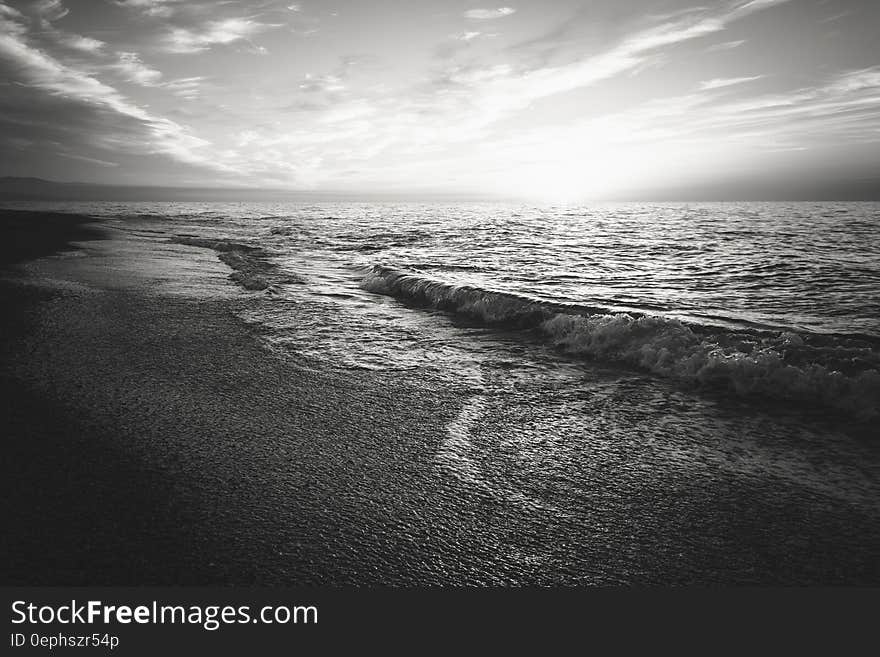 Wave washing on sandy beach in black and white. Wave washing on sandy beach in black and white.