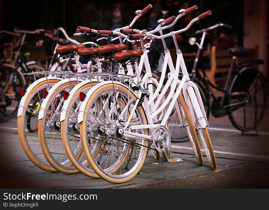 White ladies bicycles in an urban environment offered free for use to minimize pollution.