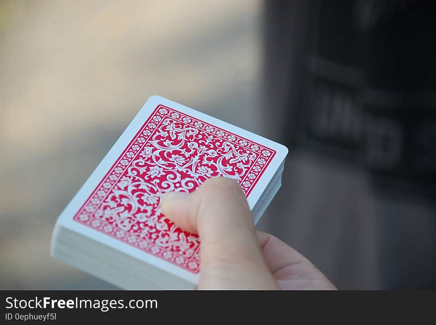 Close up of deck of red playing cards in hand. Close up of deck of red playing cards in hand.