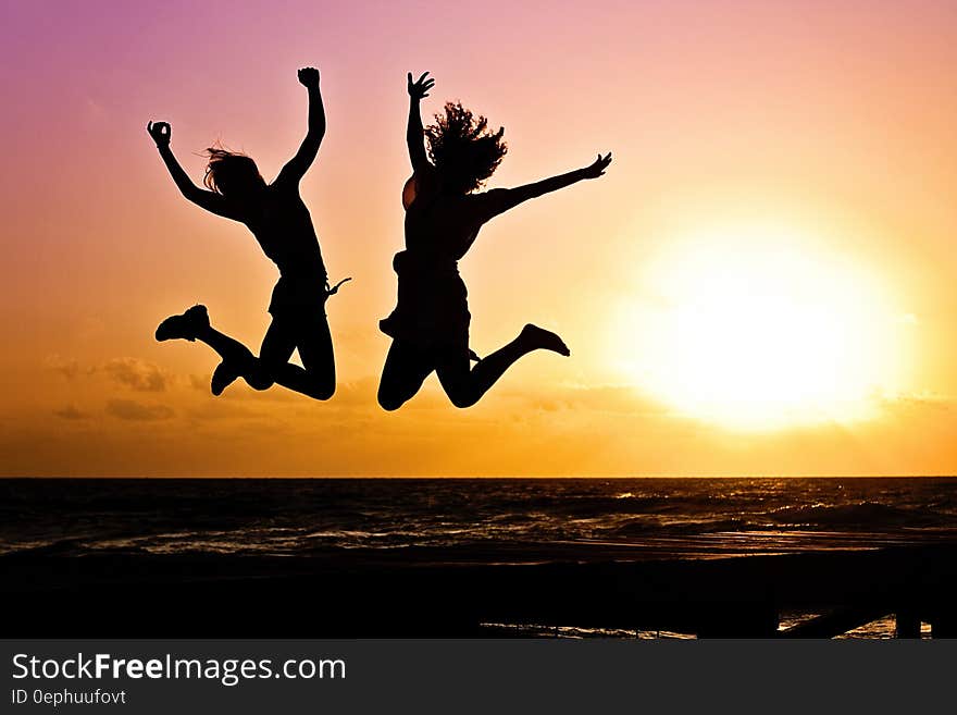 Silhouette of girls jumping on beach at sunset. Silhouette of girls jumping on beach at sunset.