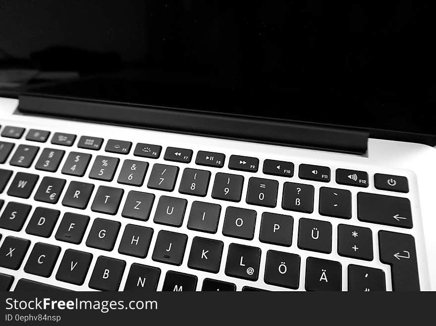 Background created by a closeup of a laptop computer showing keyboard and blank screen. Background created by a closeup of a laptop computer showing keyboard and blank screen.