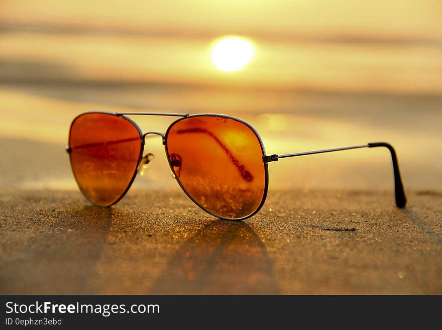 Sunglasses on sandy beach at sunset. Sunglasses on sandy beach at sunset.