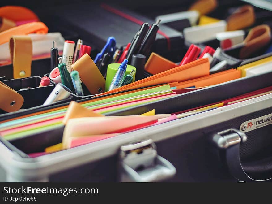 Closeup of lots of different office supplies in an open case.