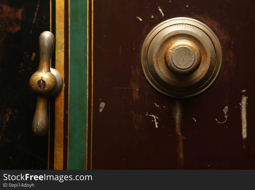 The door of a safe with a brass handle and a combination lock. The door of a safe with a brass handle and a combination lock.