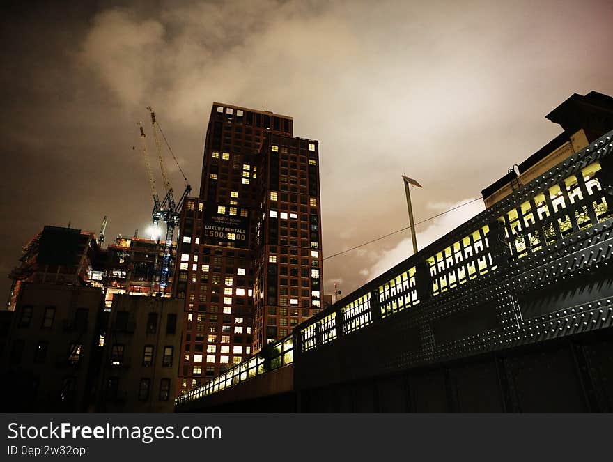 A building under construction in a city at night. A building under construction in a city at night.