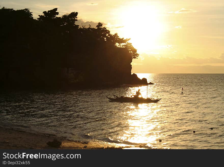 A fisherman on the sea at sunset. A fisherman on the sea at sunset.