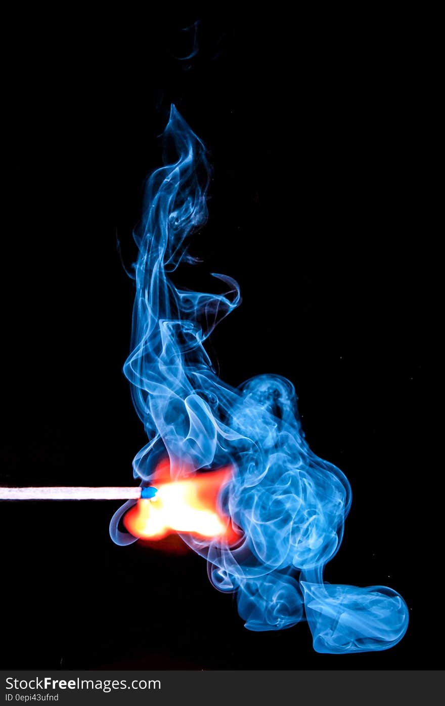 Lighted Match With Smoke on Black Background