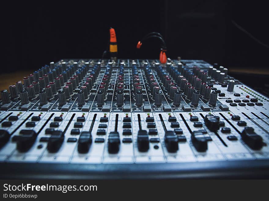 A close up of an audio mixer panel.