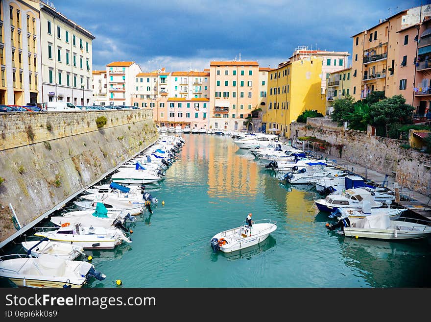 Boats anchored in a harbor on a canal in Italy. Boats anchored in a harbor on a canal in Italy.