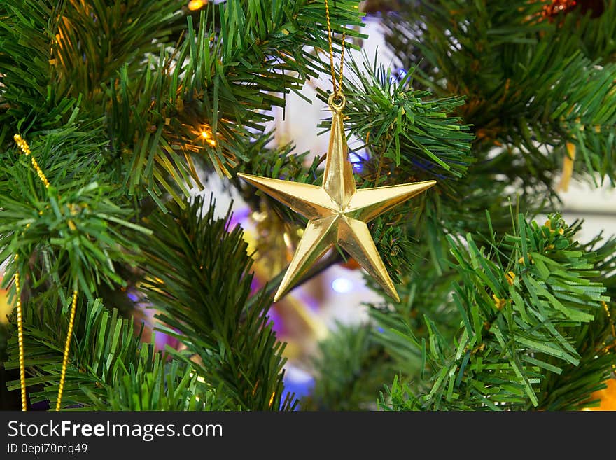 A star-shaped bauble on a Christmas tree. A star-shaped bauble on a Christmas tree.