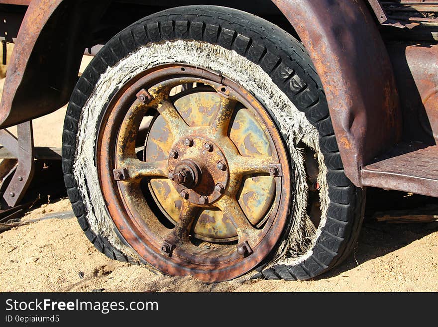 Brown Spoke Car Wheel in Brown Sand during Daytime