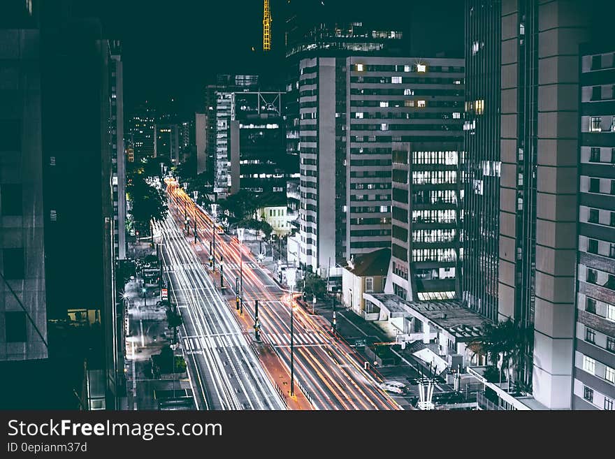 High Rise Buildings Beside Road during Nighttime