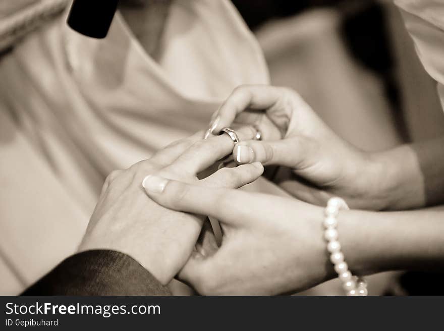 Person Putting Ring on Another Person in Grayscale Photography