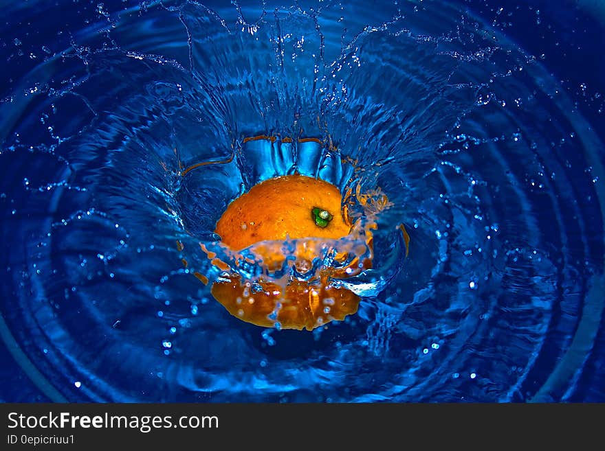 Orange Drop in Water in Time Laps Photography