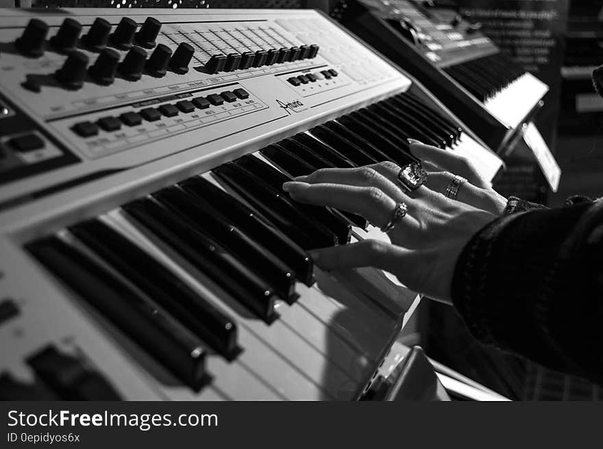 Person Playing Electric Piano in Grayscale Photo