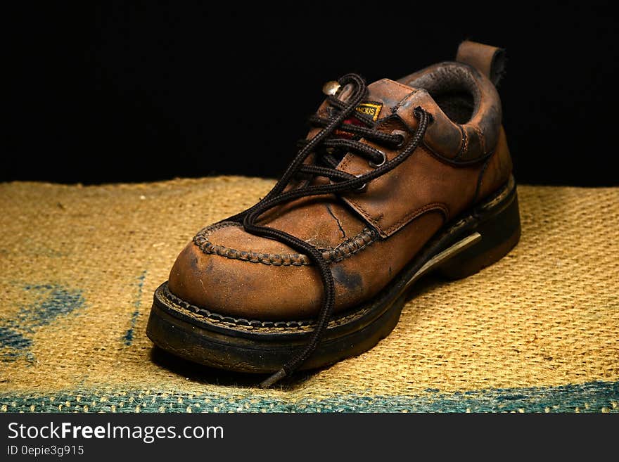 Brown and Black Leather Work Boots on Brown Surface