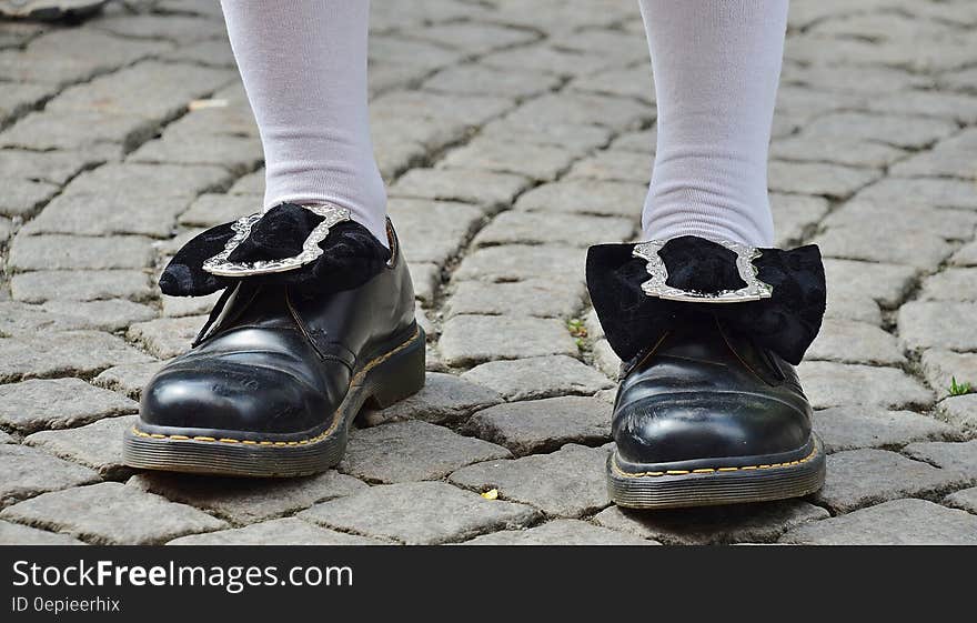 Person in Black Leather Shoes