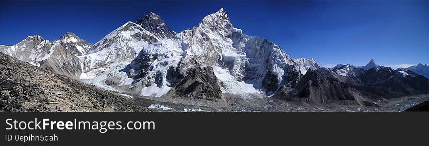 Mountain Filled With Snow Under Blue Sky during Daytime