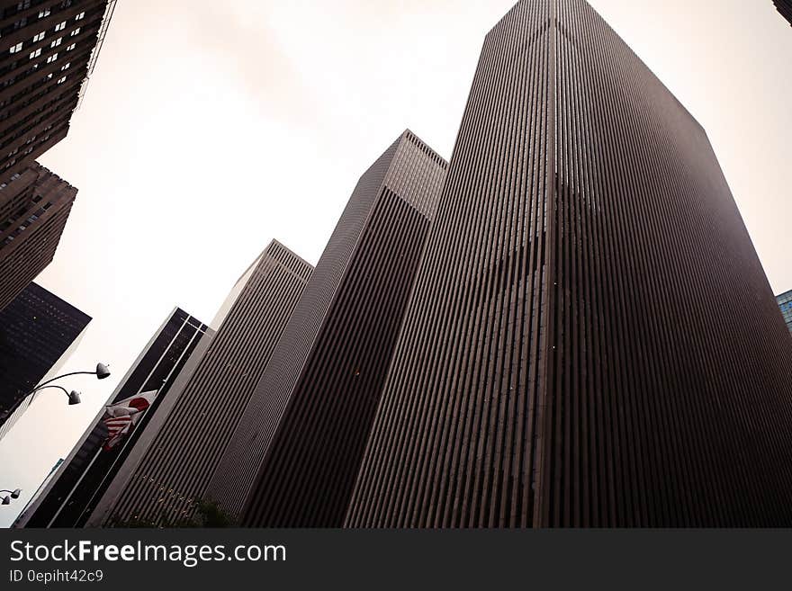 Facade of skyscraper in New York City, NY against overcast clouds. Facade of skyscraper in New York City, NY against overcast clouds.