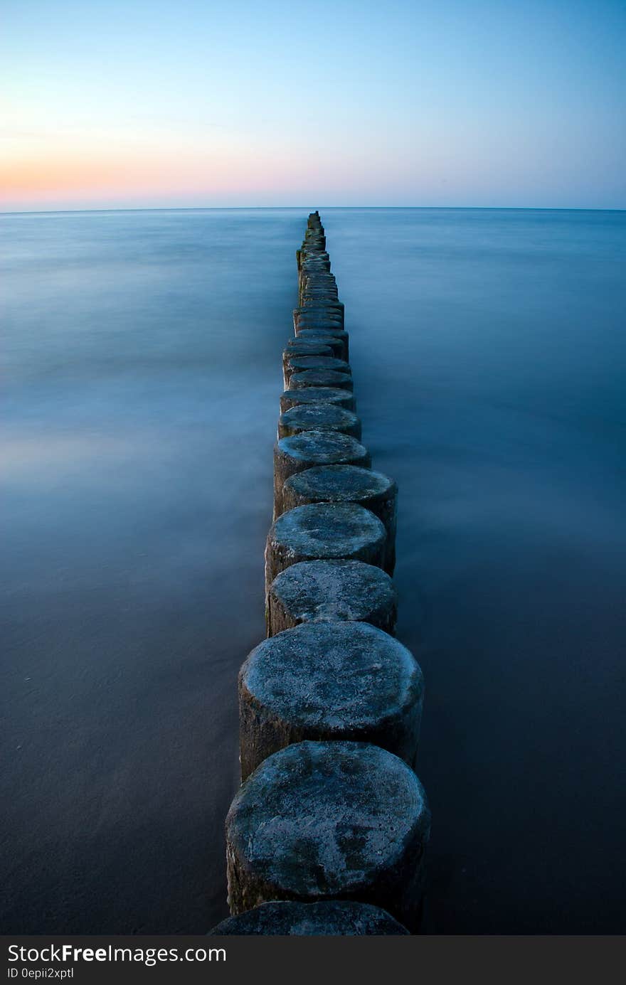 Brown Wooden Poles on Sear Water during Daytime