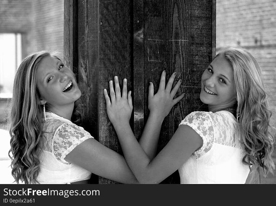 Two Women Wearing White and Lace Tops Smiling