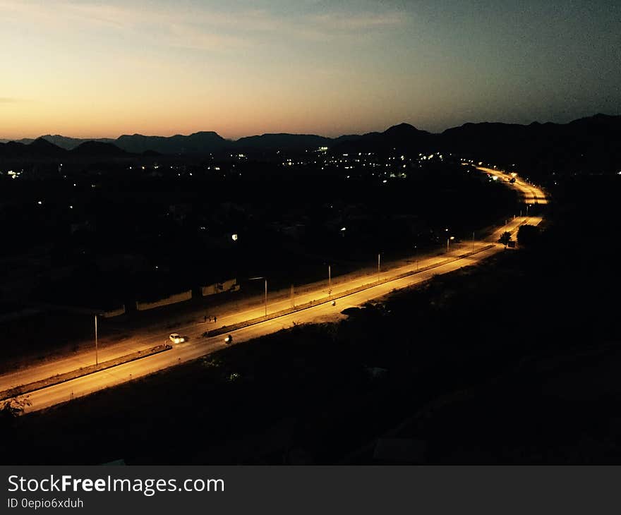 Empty highway illuminated at sunset through countryside. Empty highway illuminated at sunset through countryside.