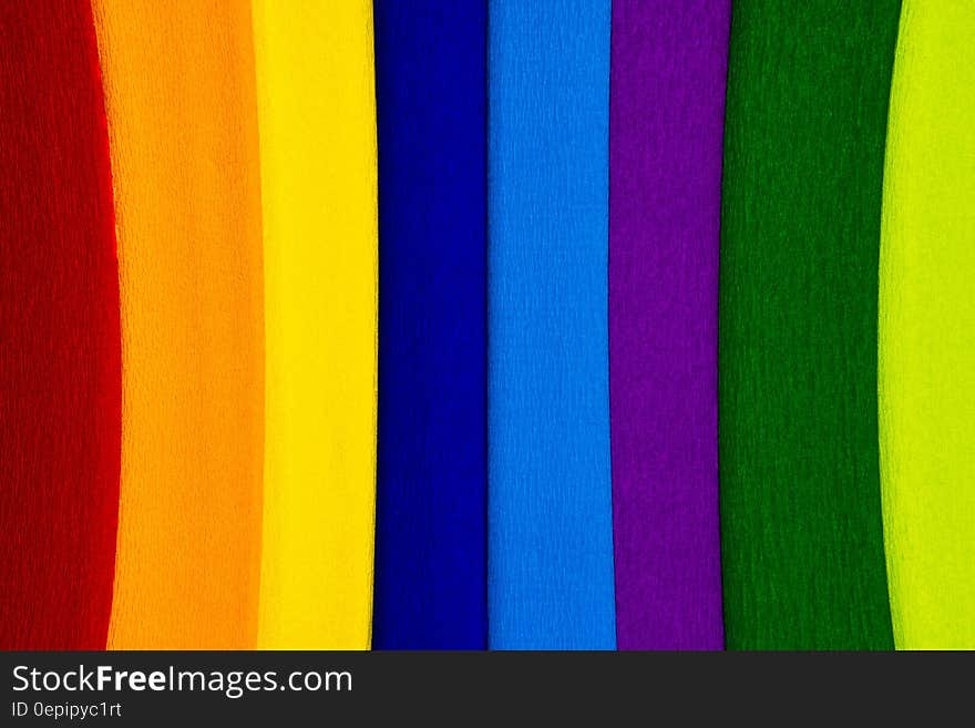 Abstract textured background of colorful vertical strips including red, orange, yellow dark blue, light blue, purple, green, lime. Abstract textured background of colorful vertical strips including red, orange, yellow dark blue, light blue, purple, green, lime.