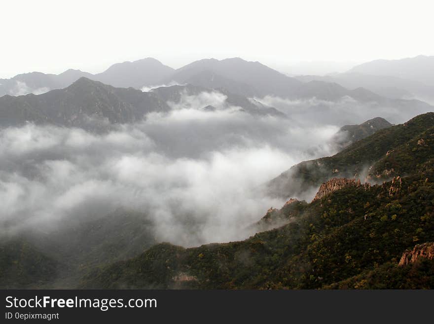 Low clouds in mountain valley on overcast day. Low clouds in mountain valley on overcast day.