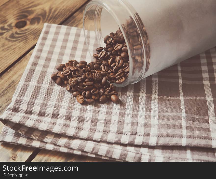 Coffee Beans Spilled on Gray and White Plaid Textile