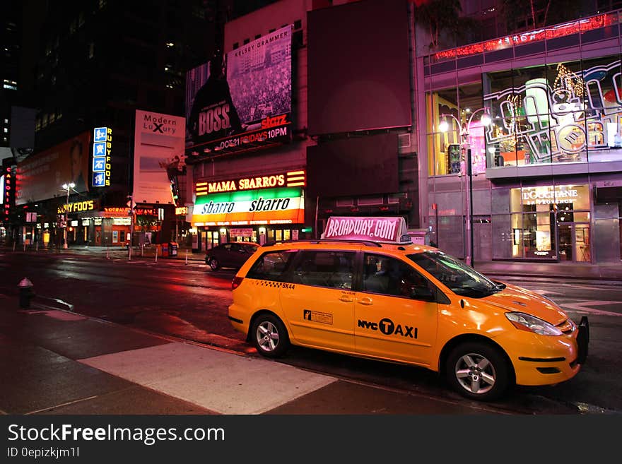 Yellow Hvc Taxi on Road during Night