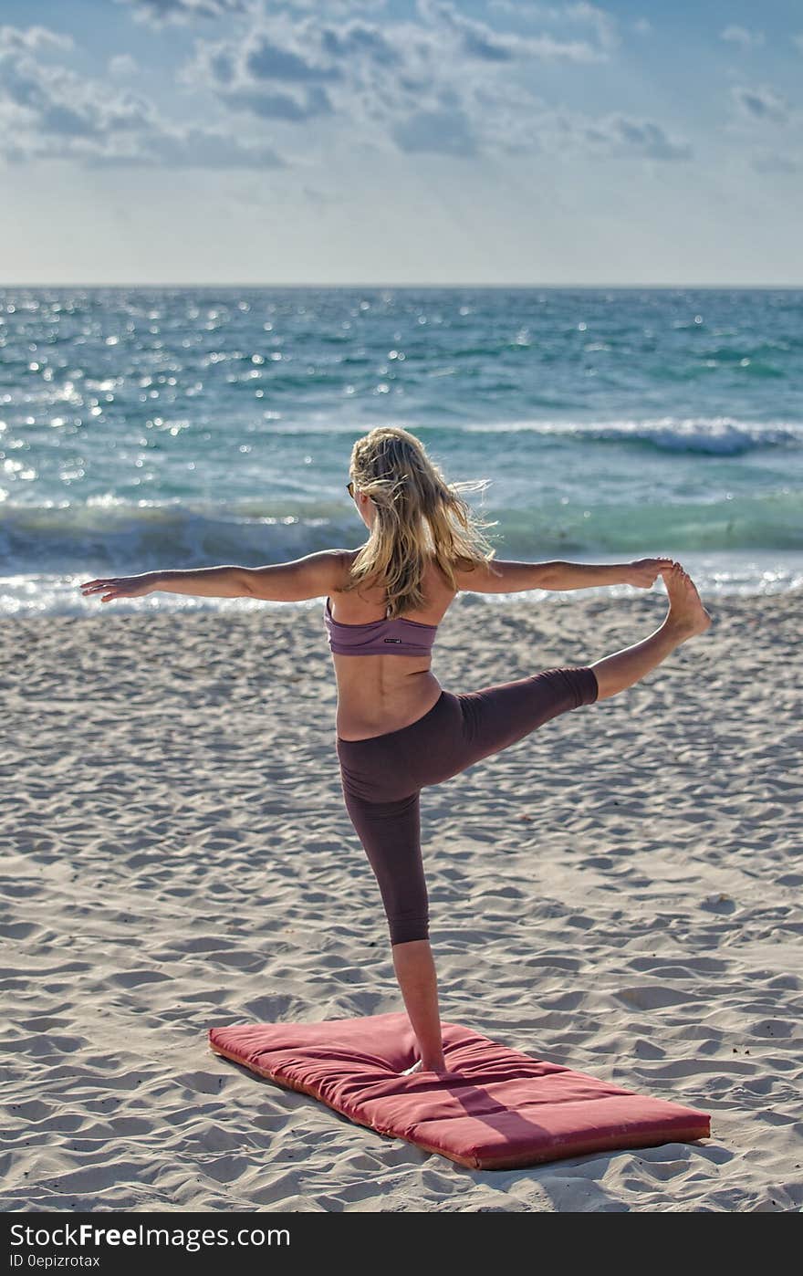 Woman Doing Yuga on Seashore