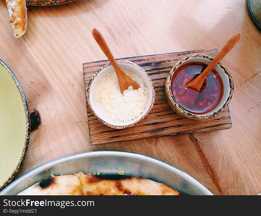 Close up of Asian condiments on wooden table. Close up of Asian condiments on wooden table.