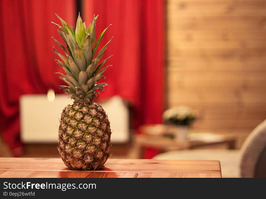 Fresh whole pineapple on wooden table indoors. Fresh whole pineapple on wooden table indoors.