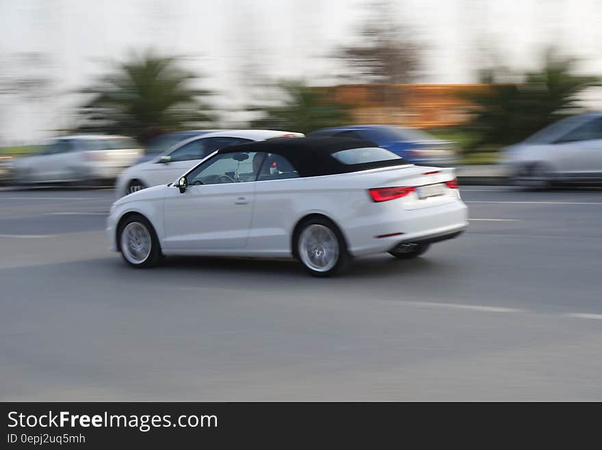 White Sports Convertible Coupe in the Middle of the Road